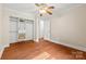 Bedroom featuring wood floors and a closet with white organizers at 18028 Broken Woods Rd, Charlotte, NC 28278