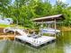 Boat dock with boat lift, chaise lounge chairs and stairs to home at 18028 Broken Woods Rd, Charlotte, NC 28278