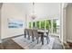 The dining room features lake views, chandelier, table with seating for six and stylish furnishings at 18028 Broken Woods Rd, Charlotte, NC 28278