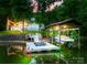 Dock with boat lift, boat, and lounge chairs overlooking the lake at 18028 Broken Woods Rd, Charlotte, NC 28278