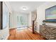 Welcoming foyer with hardwood floors, a decorative glass door, a staircase, and elegant furnishings, offering a warm invitation at 18028 Broken Woods Rd, Charlotte, NC 28278
