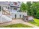 Backyard patio with a hot tub, wooden fence, and view of the home's decks at 18028 Broken Woods Rd, Charlotte, NC 28278