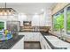 A view of the well-appointed kitchen featuring black granite counters and stainless steel appliances at 18028 Broken Woods Rd, Charlotte, NC 28278