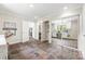 A large laundry room with washer, dryer, white cabinets, and folding table at 18028 Broken Woods Rd, Charlotte, NC 28278