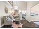 Open-concept living room with stylish seating, tiled floors, and access to the kitchen, perfect for modern living at 18028 Broken Woods Rd, Charlotte, NC 28278