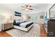 Spacious main bedroom with a ceiling fan, a large bed, and natural light at 18028 Broken Woods Rd, Charlotte, NC 28278