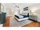 Bright main bedroom with hardwood flooring, a ceiling fan, and a large bed at 18028 Broken Woods Rd, Charlotte, NC 28278