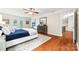 Large main bedroom with hardwood flooring, a ceiling fan, and doors to deck at 18028 Broken Woods Rd, Charlotte, NC 28278
