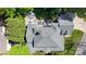 Aerial view of a luxurious home with a backyard patio, mature trees, and pristine landscaping at 18705 Harbor Light Blvd, Cornelius, NC 28031