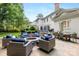 Beautiful backyard with stone patio, outdoor dining area and firepit for entertaining at 18705 Harbor Light Blvd, Cornelius, NC 28031