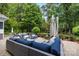 Beautifully landscaped backyard patio with comfortable seating, a dining area, and serene water features at 18705 Harbor Light Blvd, Cornelius, NC 28031