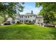 Expansive backyard with lush greenery, a fountain, and an outdoor seating area at 18705 Harbor Light Blvd, Cornelius, NC 28031