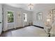 Stylish Bedroom featuring large windows, hardwood floors, and elegant decor at 18705 Harbor Light Blvd, Cornelius, NC 28031
