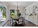 Bright dining room features a chandelier, backyard views, and custom cabinets at 18705 Harbor Light Blvd, Cornelius, NC 28031