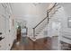 Grand foyer featuring hardwood floors, a staircase with white banisters, and an arched entry to a study at 18705 Harbor Light Blvd, Cornelius, NC 28031