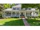 Stately white home with inviting front porch, black shutters, and manicured lawn at 18705 Harbor Light Blvd, Cornelius, NC 28031