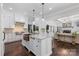 Bright kitchen boasts a large island, marble countertops, and stainless steel appliances at 18705 Harbor Light Blvd, Cornelius, NC 28031