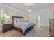 Main bedroom features neutral colors, and natural light, complemented by an elegant chandelier at 18705 Harbor Light Blvd, Cornelius, NC 28031