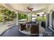 Inviting covered porch with comfortable seating area, ceiling fan, and outdoor heater at 18705 Harbor Light Blvd, Cornelius, NC 28031