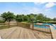 Spacious wooden deck with a view of the pool, landscaping, and the surrounding neighborhood at 188 Turnberry Ln, Mooresville, NC 28117
