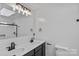 Bright bathroom featuring double sinks, sleek fixtures, and a shower behind glass at 188 Turnberry Ln, Mooresville, NC 28117