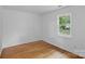 Bright, empty bedroom with hardwood floors and a window offering natural light at 188 Turnberry Ln, Mooresville, NC 28117