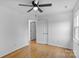 Cozy bedroom with hardwood floors, a ceiling fan, and access to storage and bathroom at 188 Turnberry Ln, Mooresville, NC 28117