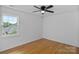 Well-lit bedroom featuring hardwood floors, a ceiling fan, and ample natural light at 188 Turnberry Ln, Mooresville, NC 28117