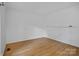 Clean, empty bedroom with hardwood floors and neutral walls, ready for personal touches at 188 Turnberry Ln, Mooresville, NC 28117