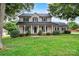 Charming two-story home with a welcoming front porch and well-manicured lawn and trimmed bushes at 188 Turnberry Ln, Mooresville, NC 28117