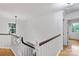Upstairs hallway featuring hardwood floors and a staircase with wood handrails at 188 Turnberry Ln, Mooresville, NC 28117