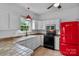 Bright kitchen with white cabinets and retro red refrigerator at 188 Turnberry Ln, Mooresville, NC 28117
