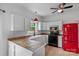 Charming kitchen with white cabinets and a retro red refrigerator at 188 Turnberry Ln, Mooresville, NC 28117
