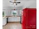 Bright kitchen features white cabinets, and retro red refrigerator at 188 Turnberry Ln, Mooresville, NC 28117
