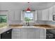 Clean kitchen with white cabinets, and a view to the outdoors at 188 Turnberry Ln, Mooresville, NC 28117