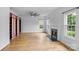 Spacious living room with fireplace, wood floors, ceiling fan, and custom built-in shelving at 188 Turnberry Ln, Mooresville, NC 28117