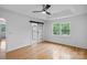 Main bedroom with hardwood floors, ceiling fan, and en suite bath featuring sliding door at 188 Turnberry Ln, Mooresville, NC 28117