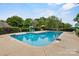 A private outdoor pool is surrounded by lush greenery and lounge chairs at 188 Turnberry Ln, Mooresville, NC 28117