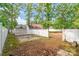 Fenced backyard offering privacy, shed, wooded views, and potential for outdoor enjoyment at 2020 Olde Towne Dr, Monroe, NC 28110