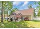 Outdoor patio with barbecue area surrounded by mature trees and lush landscaping in backyard at 2020 Olde Towne Dr, Monroe, NC 28110