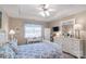 Bright bedroom with tray ceilings, blue patterned bedding, and matching window valances at 2020 Olde Towne Dr, Monroe, NC 28110