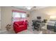 Bedroom featuring a red loveseat and a desk with computer setup, perfect for a home office at 2020 Olde Towne Dr, Monroe, NC 28110