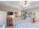 Bright bedroom with tray ceilings, blue patterned bedding, and a view to the bathroom at 2020 Olde Towne Dr, Monroe, NC 28110
