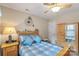 Cozy bedroom with wood furniture, a ceiling fan, and blue accents creating a welcoming atmosphere at 2020 Olde Towne Dr, Monroe, NC 28110