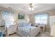 Bright bedroom with tray ceilings, blue patterned bedding, and matching window valances at 2020 Olde Towne Dr, Monroe, NC 28110