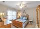 Serene bedroom with natural lighting, ceiling fan, and coordinated decor creating a comforting space at 2020 Olde Towne Dr, Monroe, NC 28110