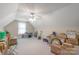 Large bonus room with carpeting, neutral walls, and a variety of storage boxes and furniture at 2020 Olde Towne Dr, Monroe, NC 28110