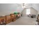 Spacious bonus room featuring neutral carpeting, sloped ceilings, and a window for natural light at 2020 Olde Towne Dr, Monroe, NC 28110