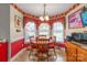 Bright dining area with a round table, chairs, and large windows for natural light at 2020 Olde Towne Dr, Monroe, NC 28110