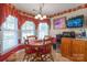 Cozy dining area with a round table, four chairs, and large windows for natural light at 2020 Olde Towne Dr, Monroe, NC 28110